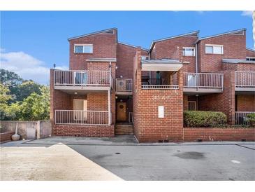 Brick townhouse complex with balconies, landscaping, and easy access to parking in a vibrant neighborhood at 385 Ralph Mcgill Ne Blvd # D, Atlanta, GA 30312