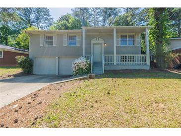 Charming split-level home with a welcoming front porch and a two-car garage at 1477 Patricia Dr, Morrow, GA 30260