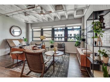 Contemporary living room featuring exposed ceiling, hardwood floors, and lots of natural light at 878 Peachtree Ne St # 535, Atlanta, GA 30309