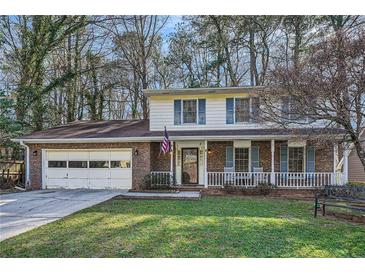 Charming brick two-story home with a front porch and attached garage at 4113 Stutz Ct, Tucker, GA 30084
