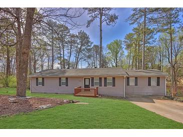 Charming single-story home featuring a manicured lawn and welcoming front porch at 3618 Mansfield Ln, Snellville, GA 30039