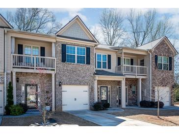 Charming townhome featuring a brick facade, balconies, and attached garage in a desirable neighborhood at 2544 Castellan Dr, Atlanta, GA 30316
