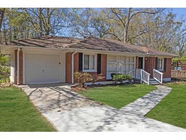 Charming brick ranch home with a well-maintained lawn and driveway leading to an attached garage at 2261 Headland Ter, Atlanta, GA 30344