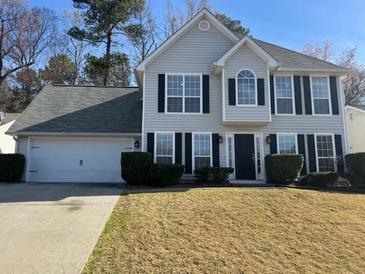 Charming two-story home with a well-manicured lawn, attached garage, and welcoming front entrance at 2295 Golden Valley Dr, Lawrenceville, GA 30043