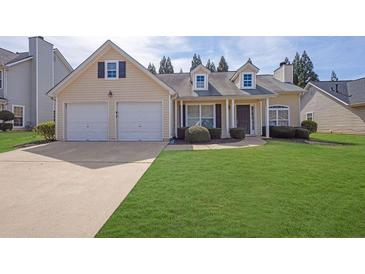 Charming one-story home with a well-maintained lawn and two-car garage at 5016 Larkspur Ln, Atlanta, GA 30349