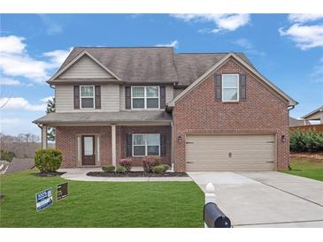 Charming two-story home featuring a brick and siding exterior with a well-manicured front yard at 5414 Splendida Ct, Fairburn, GA 30213