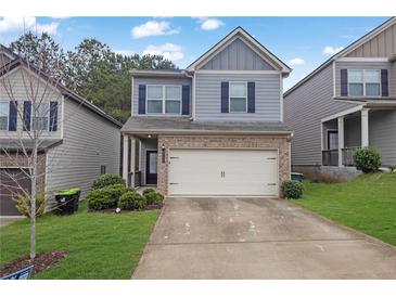 Charming two-story home with a brick and siding exterior and a two-car garage at 5456 Union Hill Ct, Union City, GA 30291