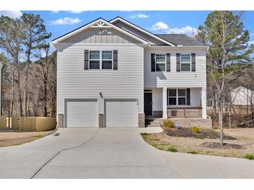 Charming two-story home with a two-car garage, black shutters, and a cozy front porch at 1054 Mackets Ct, Atlanta, GA 30354