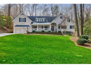 Charming home featuring a well-manicured lawn and inviting front porch with a combination of painted brick and siding at 3790 Narmore Ne Dr, Atlanta, GA 30319