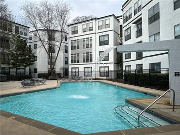 Relaxing pool with waterfall feature and sunning area for residents and guests at 821 Ralph Mcgill Ne Blvd # 3209, Atlanta, GA 30306