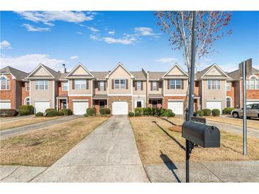 Attractive townhome exteriors with landscaped front yards and attached garages at 156 Haven Oak Way, Lawrenceville, GA 30044