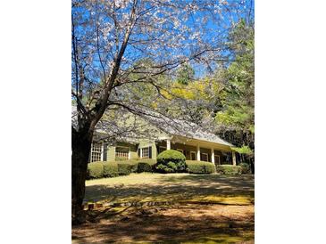 Charming exterior view of home with beautiful flowering trees and manicured landscaping at 917 Greymont Nw Cir, Marietta, GA 30064