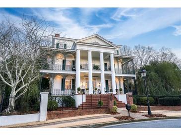 Stately two-story home with grand columns and wrought iron balconies at 3816 Turnberry Ct, Duluth, GA 30096