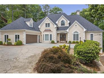 Elegant two-story home with a manicured lawn, attached garage, and covered entryway at 2885 Coles Way, Atlanta, GA 30350