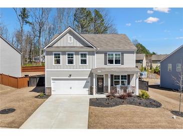Charming two-story home with a well-manicured lawn and a welcoming front porch at 311 Ivy Chase Loop, Dallas, GA 30157