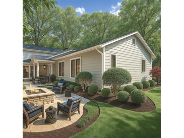 A well-manicured backyard featuring a stone firepit and ample seating with professionally landscaped plantings at 6405 Cherry Tree Ln, Atlanta, GA 30328