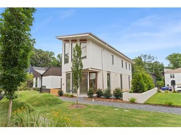 Modern two-story home with clean lines, complemented by landscaped front yard and gravel walkway at 370 2Nd St, Fayetteville, GA 30214