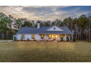 Charming single-story home featuring a welcoming front porch and lush lawn at 5761 Dixie Hwy, Rutledge, GA 30663