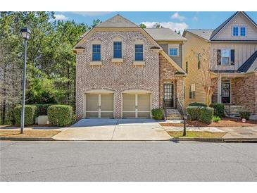 Charming brick front exterior with a two-car garage and well-maintained landscaping at 189 Privet Cir, Suwanee, GA 30024