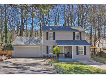 Charming two-story home features a well-maintained front yard and attached two-car garage at 4663 Hairston Crossing Pl, Stone Mountain, GA 30083
