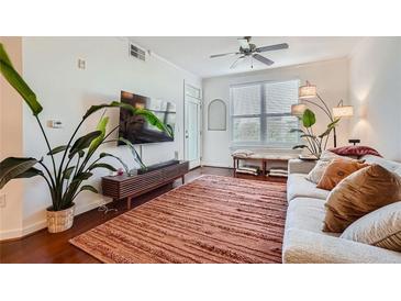 Inviting living room featuring a comfortable sofa, modern lighting, and a stylish rug at 390 17Th Nw St # 4031, Atlanta, GA 30363