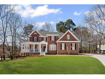 Charming brick home with a manicured lawn and inviting front porch, perfect for relaxing and enjoying the neighborhood at 4140 Hillsborough, Cumming, GA 30041