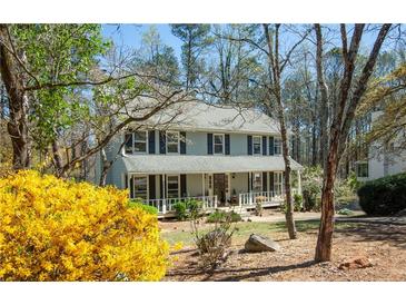 Inviting two-story home with a charming front porch and well-maintained landscaping at 959 Hampton Nw Trl, Lilburn, GA 30047