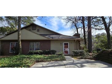 Charming brick and siding home with well-maintained landscaping and mature trees at 4858 Westridge Dr, Norcross, GA 30093