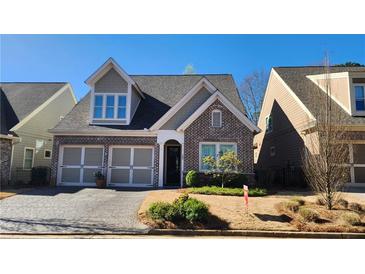 Charming brick-and-siding home featuring an attached two-car garage and well-maintained landscaping at 188 Foxtail Rd, Woodstock, GA 30188