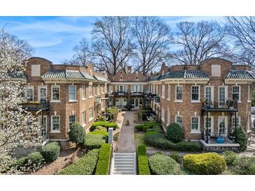 Beautiful brick apartment building featuring manicured landscaping and a central courtyard at 907 Piedmont Ne Ave # 7, Atlanta, GA 30309