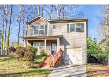 Charming two-story home features a covered front porch and a well-manicured lawn at 3575 Bonneville Dr, Cumming, GA 30041