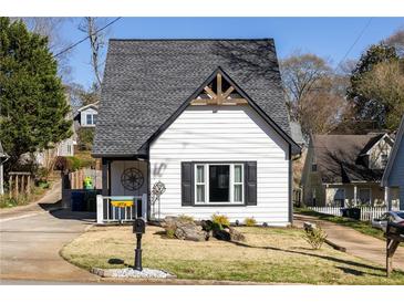 Charming home featuring a classic gable roof, black shutters, and a well-manicured lawn at 974 Grant Se St, Atlanta, GA 30315