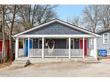 Charming bungalow with a cozy front porch and colorful doors at 109 Chester Se Ave, Atlanta, GA 30316