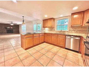 Bright eat-in kitchen featuring granite countertops, stainless appliances, and tile flooring at 320 Six Branches Ct, Roswell, GA 30076