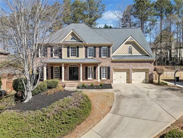 Beautiful two-story brick home with a well-manicured lawn and a spacious two-car garage at 4312 White Hickory Nw Ln, Kennesaw, GA 30152