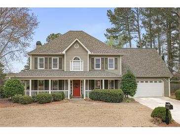 Charming two-story home with a large front porch, manicured lawn, and two-car garage at 6011 Fairlong Nw Ct, Acworth, GA 30101
