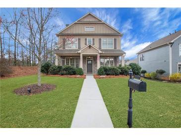 Charming two-story home featuring a manicured lawn and inviting front porch, perfect for a Gathering at 1803 Stone Bridge Way, Marietta, GA 30064