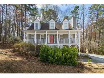 Charming two-story home with a welcoming front porch and well-maintained landscaping at 55 Legend Creek Cove, Douglasville, GA 30134