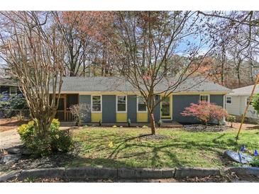 Charming single story home with a freshly cut lawn, mature landscaping, and blue accents at 621 Spruce Dr, Stone Mountain, GA 30083