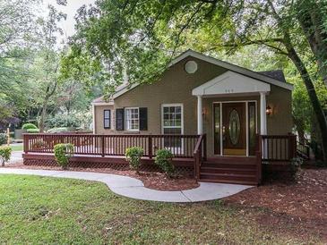 Charming single story brick home with a large front porch and well-maintained landscaping at 2380 Strathmore Dr, Atlanta, GA 30324