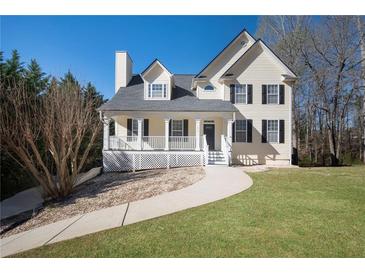 Charming two-story home with a welcoming front porch and well-maintained lawn at 274 Sleepy Hollow Rd, Powder Springs, GA 30127