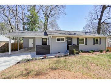 Charming single-story home with gray brick, black shutters, and a cozy front porch at 4985 Crowe Se Dr, Smyrna, GA 30082