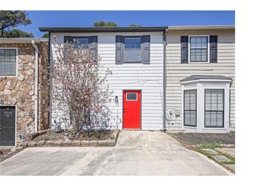 Charming townhome featuring a vibrant red front door and mature landscaping at 3505 Miller St # D, Lithia Springs, GA 30122