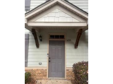 Inviting front door with covered entrance and stone accents providing a welcoming curb appeal at 4155 Park Chase Dr, Atlanta, GA 30344