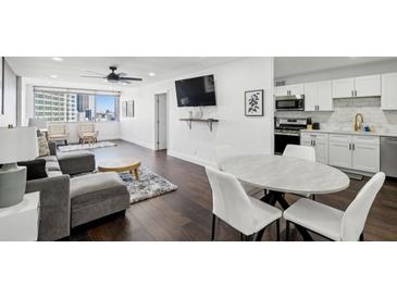 Bright open-concept living room with modern finishes and dining area with lovely city views at 215 Piedmont Ne Ave # 2201, Atlanta, GA 30308