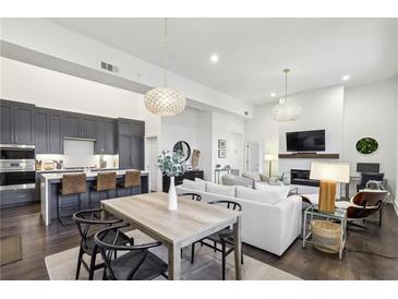 Open concept living with a kitchen featuring an island and barstool seating at 1200 Ponce De Leon Ne Ave # A1, Atlanta, GA 30306
