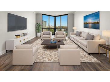 Bright living room features large windows with city views and sleek modern furnishings at 2870 Pharr Court South Nw # 1202, Atlanta, GA 30305