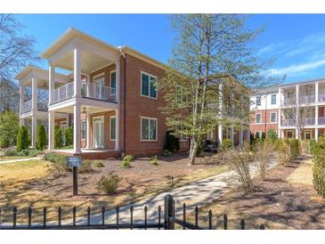 Beautiful brick townhome with white trim, featuring double balconies and well-maintained landscaping at 1200 Ponce De Leon Ne Ave # A-19, Atlanta, GA 30306