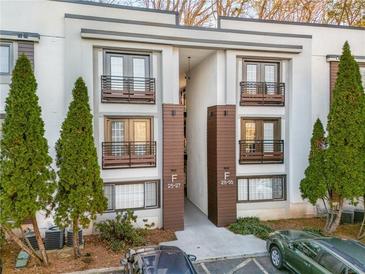 Attractive exterior with two-story units, brown accents, and mature evergreens for enhanced curb appeal at 1445 Monroe Ne Dr # G3, Atlanta, GA 30324