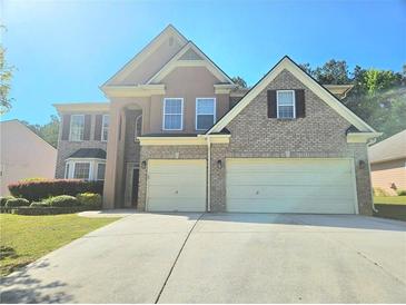Charming two-story home featuring a two-car garage and manicured landscaping at 1172 Preserve Park Dr, Loganville, GA 30052
